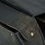 close up of brown saddlebag button flap